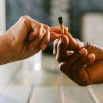 An Image of two male hands passing a joint. Cannabis culture from Design 710