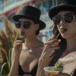 Stylish individuals enjoying the Atlantic City boardwalk with cannabis edibles.